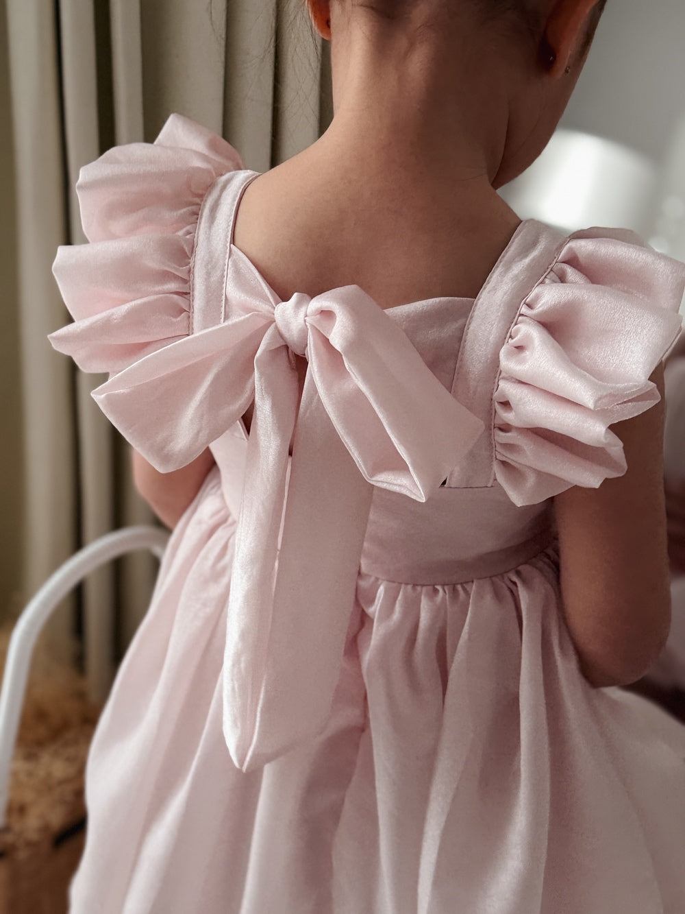 Little girls shimmery pink party dress with flutter sleeves