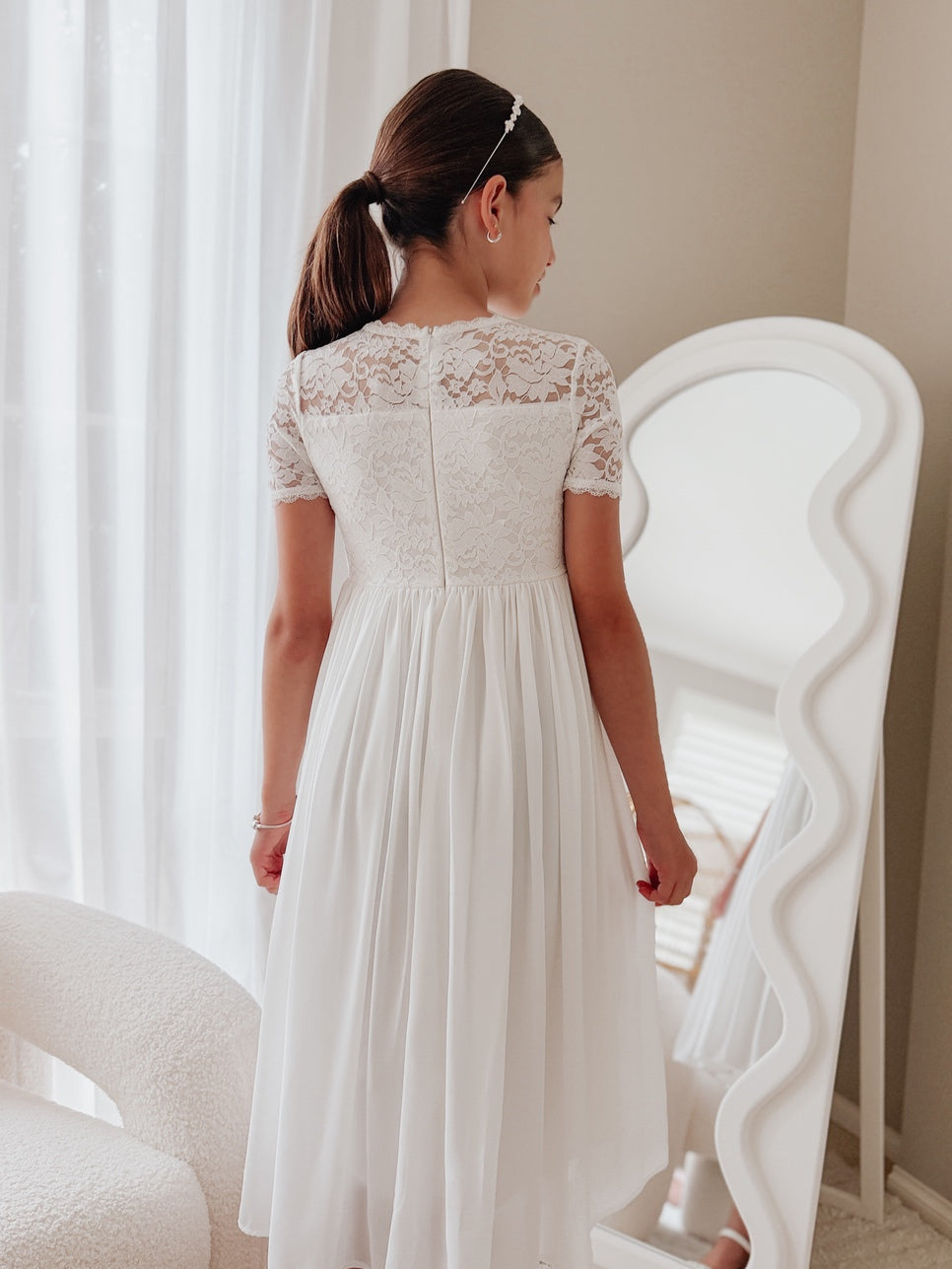 White lace bodice detail on girls white communion dress