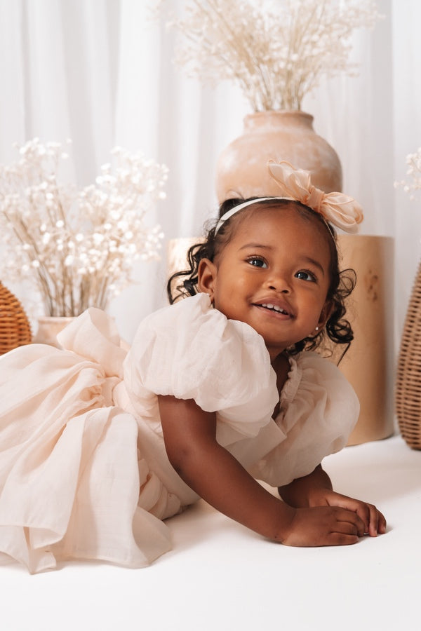Baby flower girl dress in soft champagne with bow back