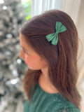 Mini green bows styled with girls' Christmas outfit