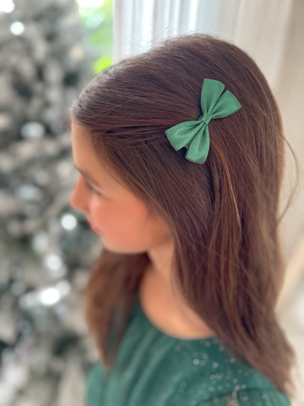Mini green bows styled with girls' Christmas outfit