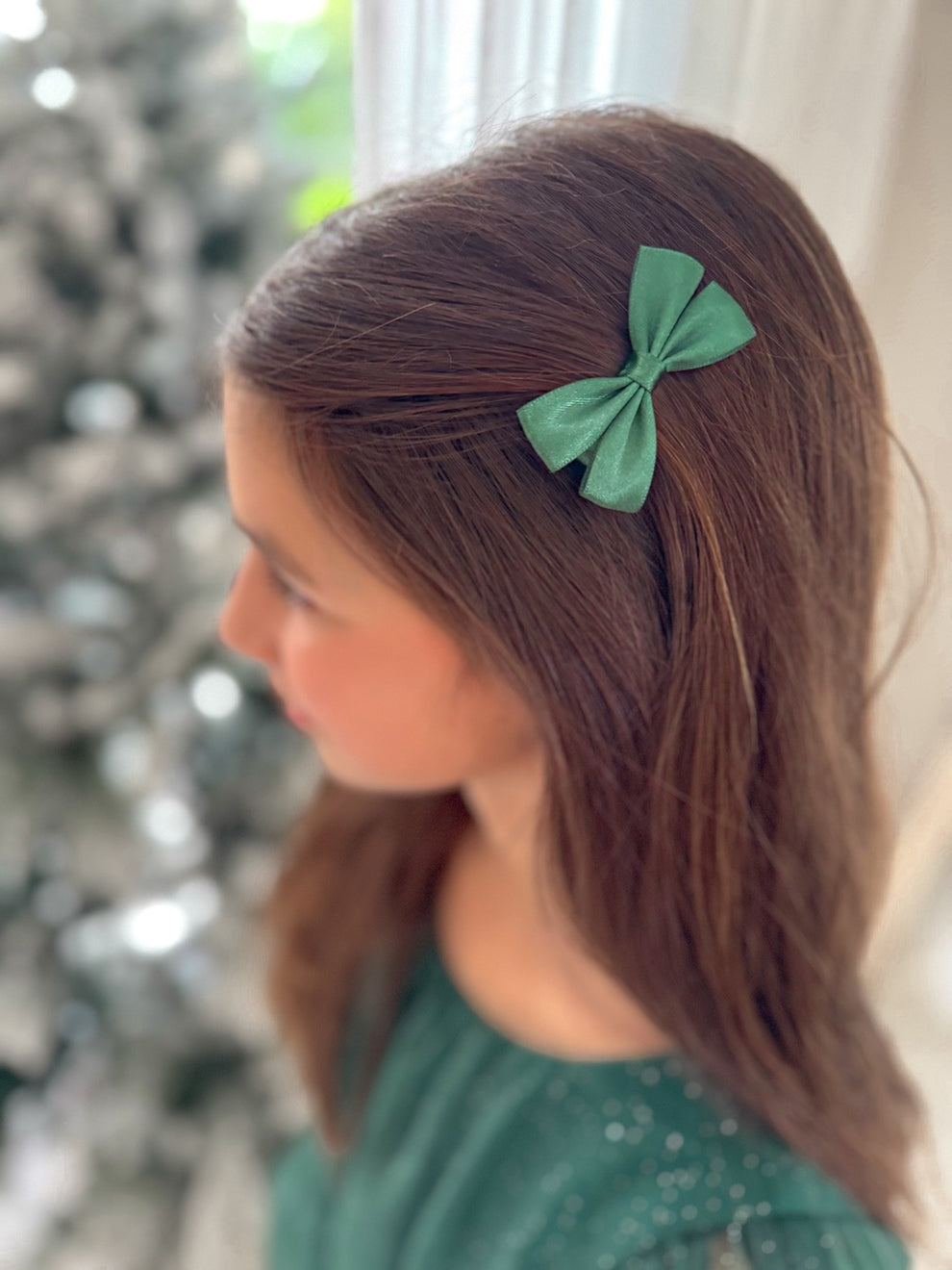 Mini green bows styled with girls' Christmas outfit