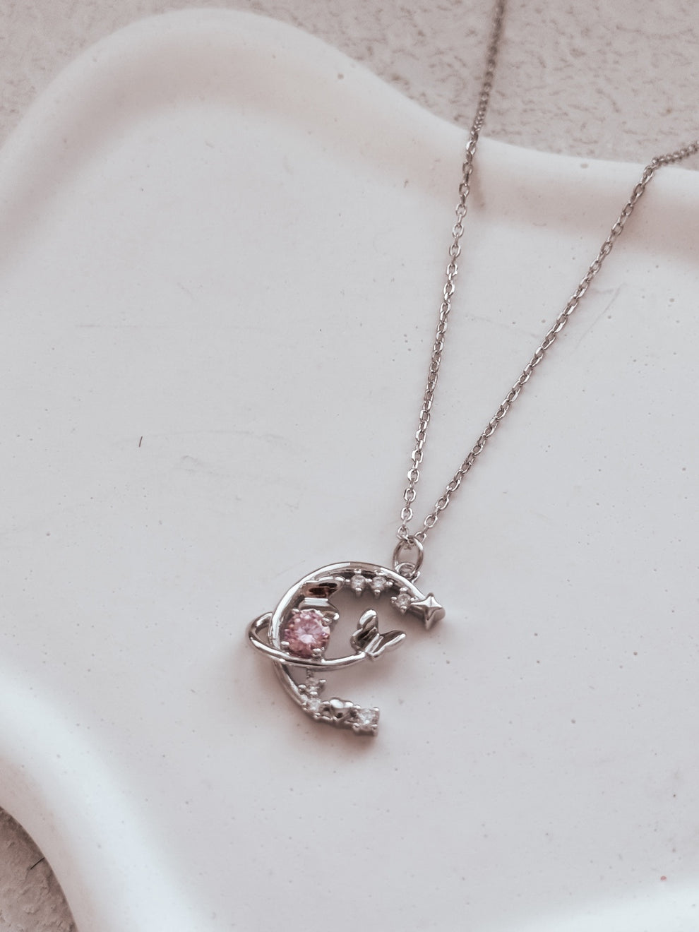 Close-up of crescent moon girls necklace with detailed sparkle accents
