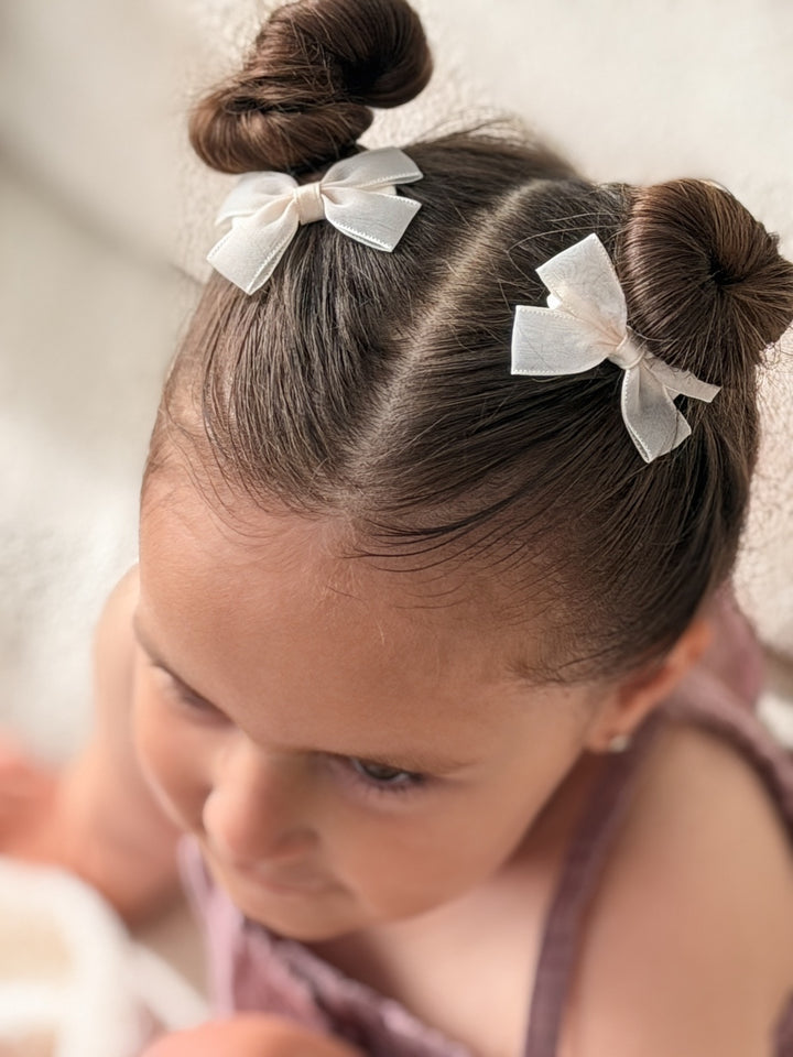 Ivory ribbon bows with stitched edging