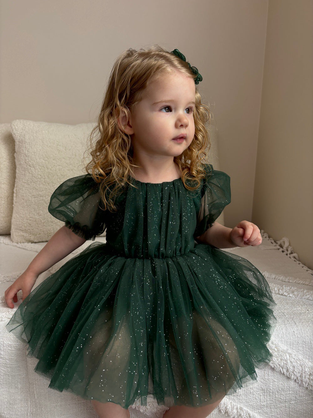 Nina Green Sparkle Christmas Romper - Christmas Dresses and RompersClose-up of green sparkle fabric on baby Christmas romper catching festive light