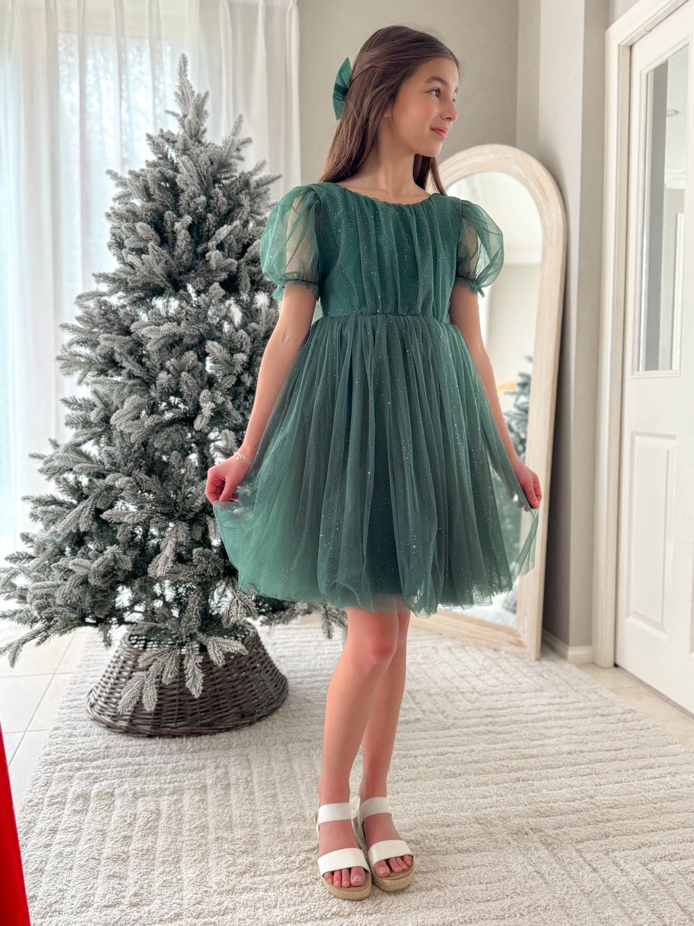 Front view of festive girls green holiday dress with shimmer detail