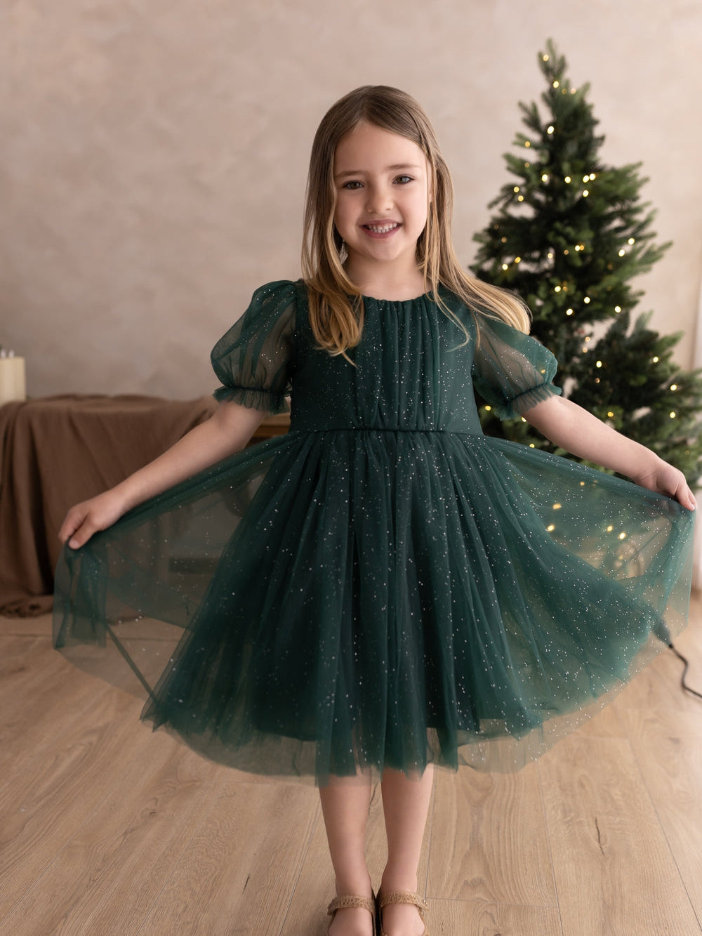 Girls green sparkly Christmas party dress modelled from the front