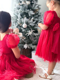 Girls Christmas dress in red with shimmer fabric and bow detail