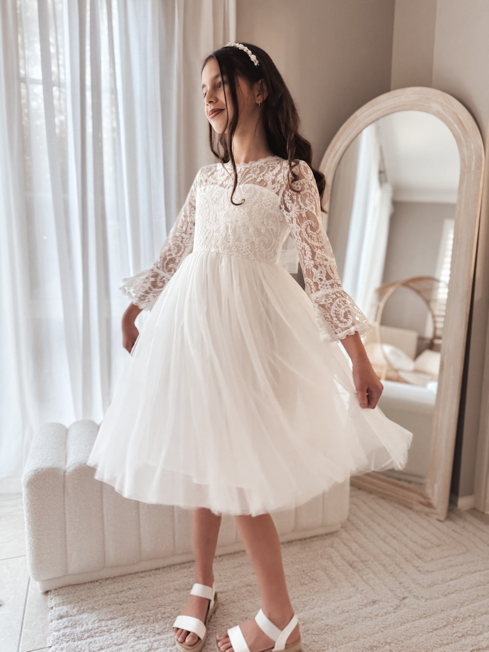 Odette Girls White Dress - Knee Length - Flower Girl DressesModel twirling in Odette dress, showcasing dress movement and volume.