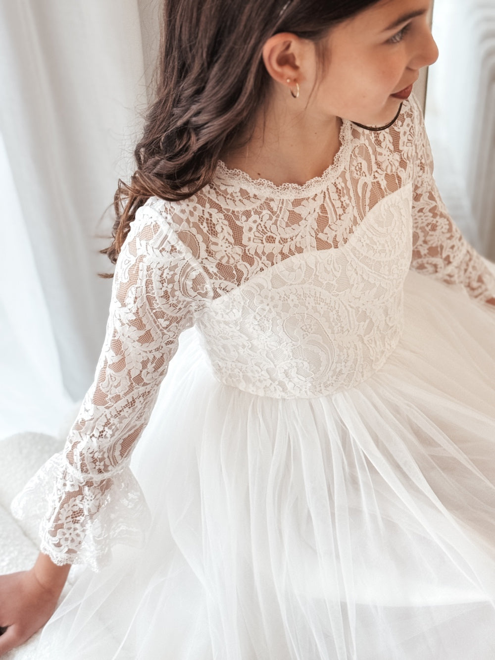 Close-up of lace bodice and bell sleeves on the Odette white dress.