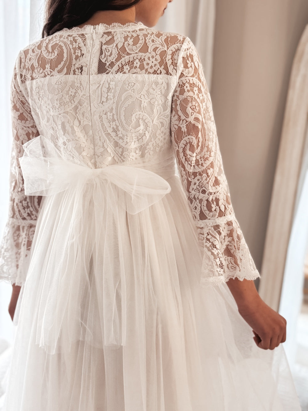 Back view of the Odette dress highlighting the satin bow and zip-up detail.
