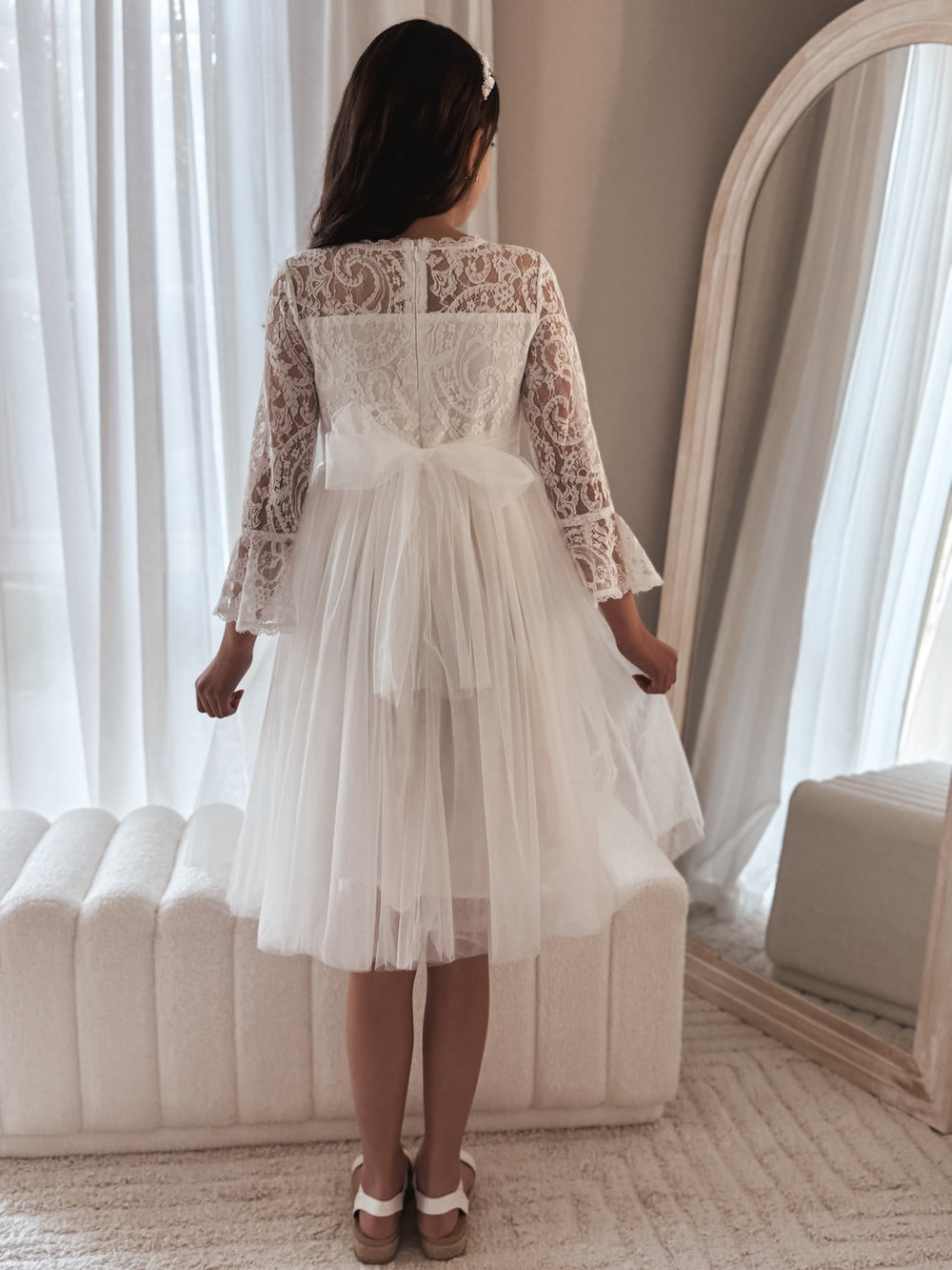 Close-up of lace bodice and bell sleeves on the Odette white dress.