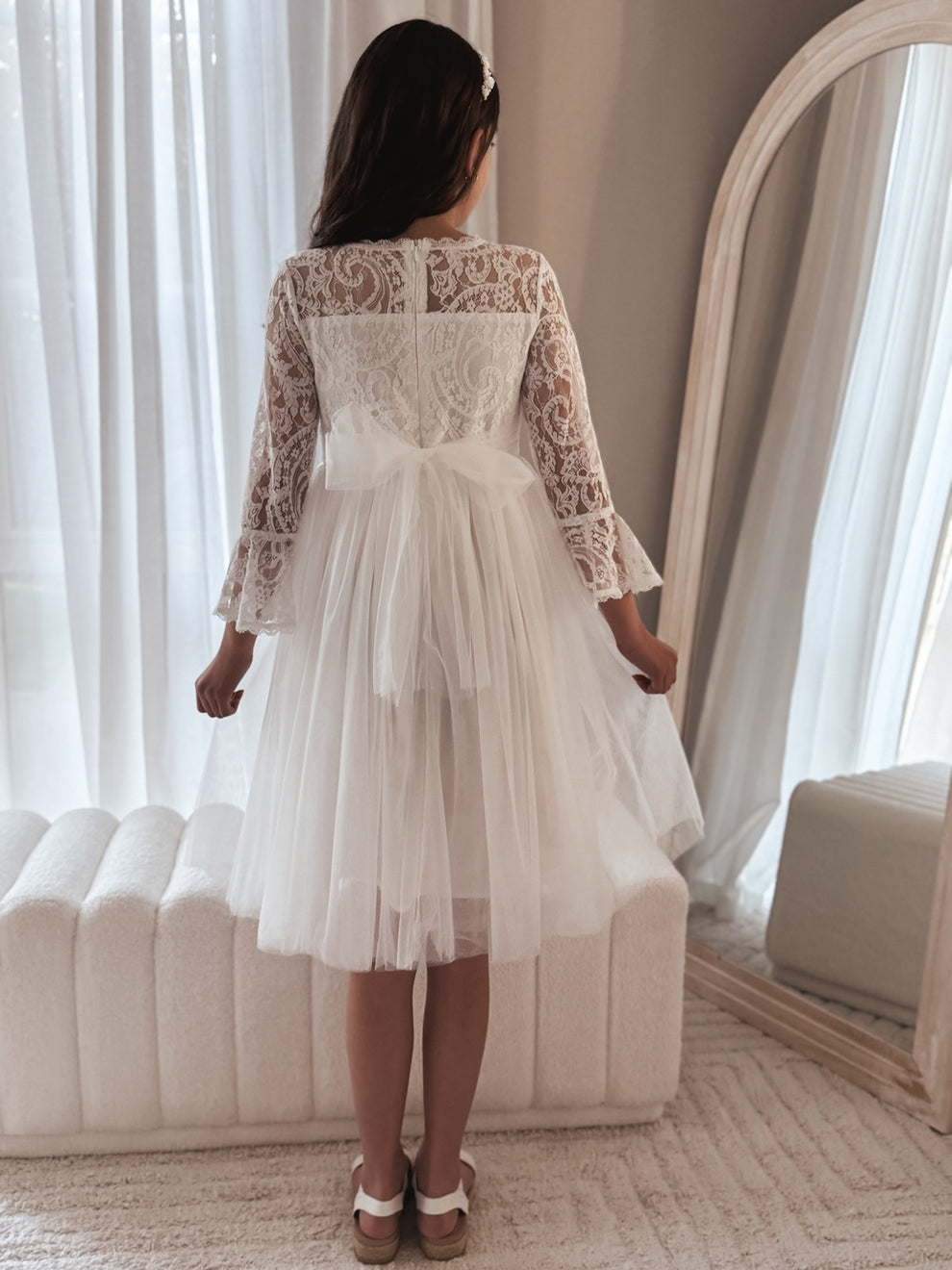 Close-up of lace bodice and bell sleeves on the Odette white dress.