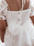 Back detail – tulle bow and three-button fastening on Petal White Baby Dress