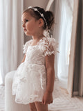 Close-up of embroidery detail on Petal White Baby Dress bodice and skirt