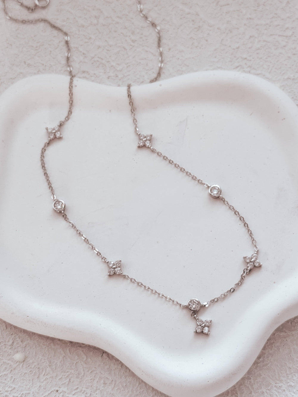 Adjustable girls necklace featuring flowers and diamond accents