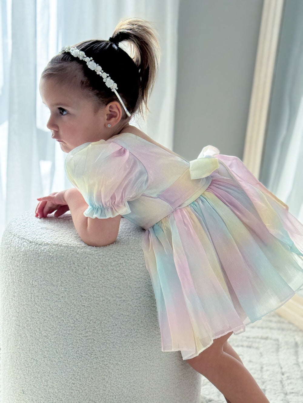 Side angle of girls headband featuring solid white flowers and diamantes