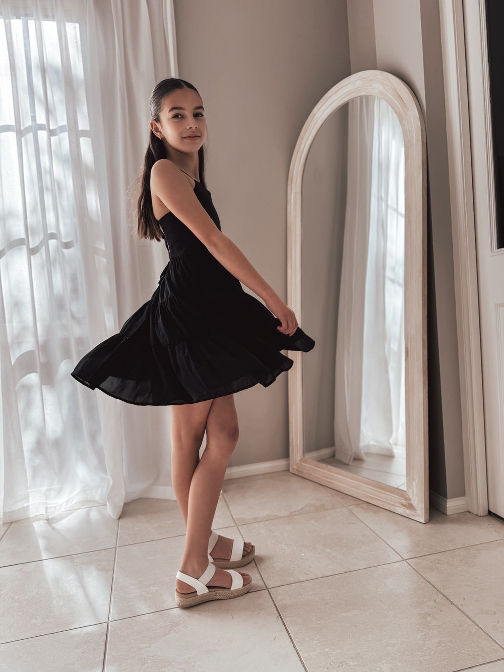 Tween girl in elegant black dress for Year 6 graduation photoshoot