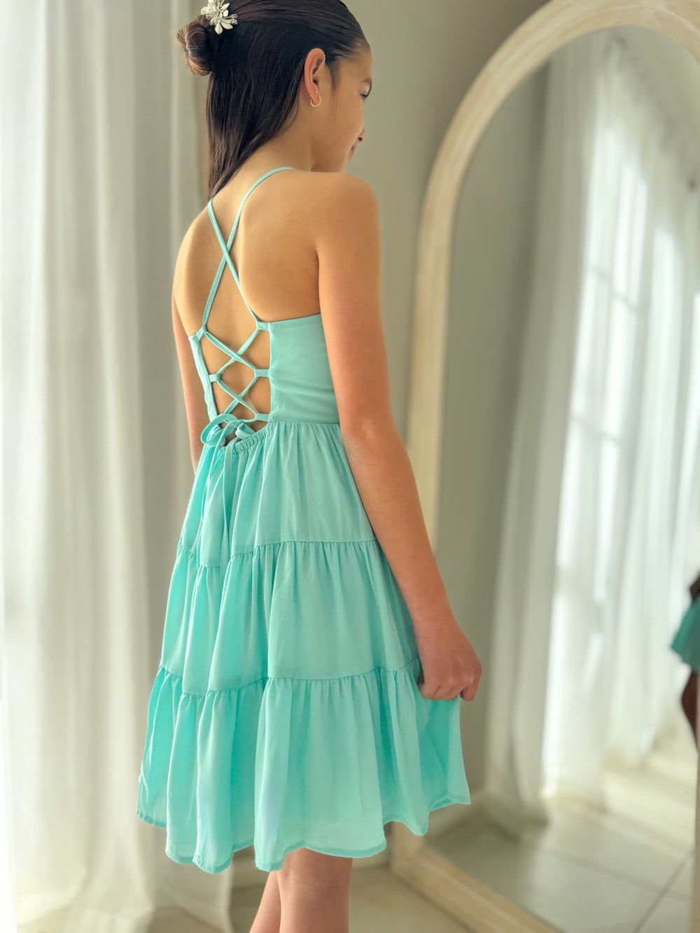 Back view showing tie-up feature on turquoise primary graduation dress