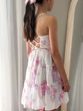 Tween girl wearing pink floral chiffon graduation dress with layered skirt