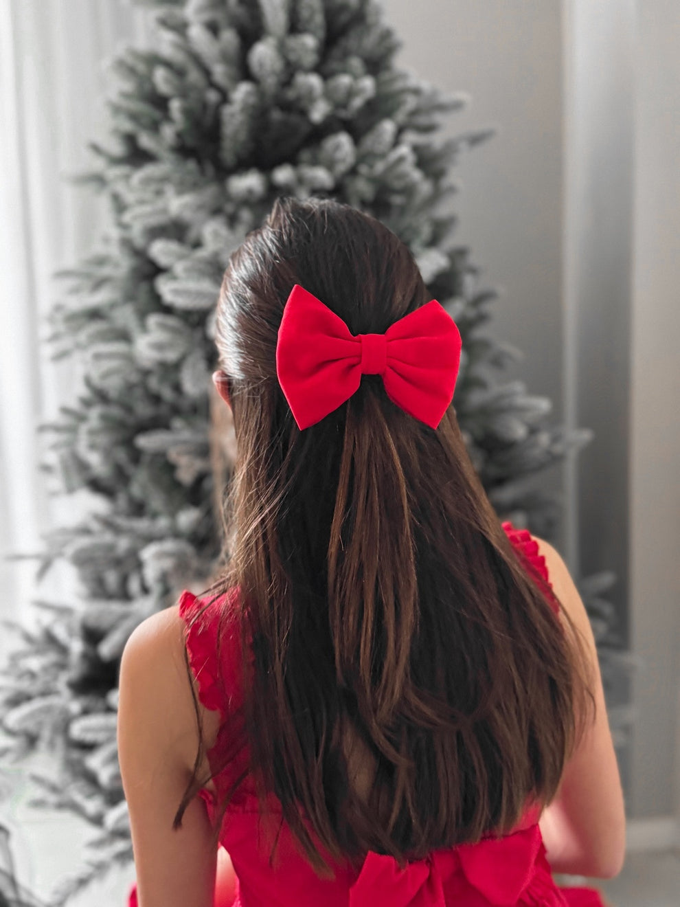 Close-up of Phoebe red girls Christmas bow