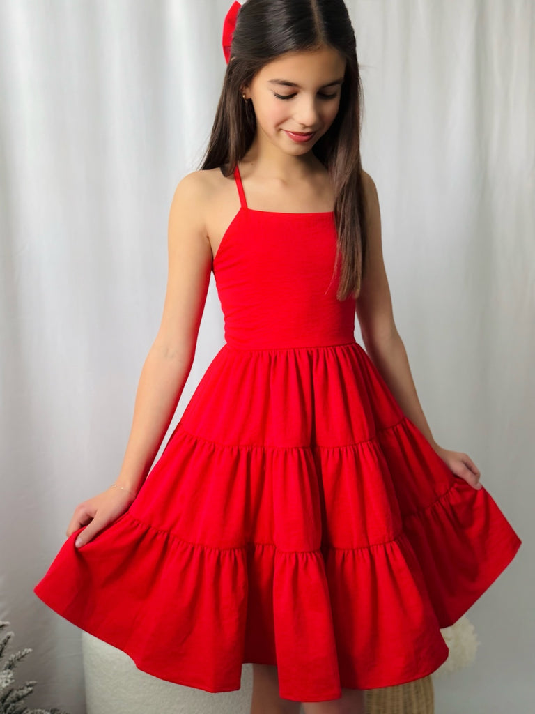 Red holiday dress for girls with tiered skirt on display