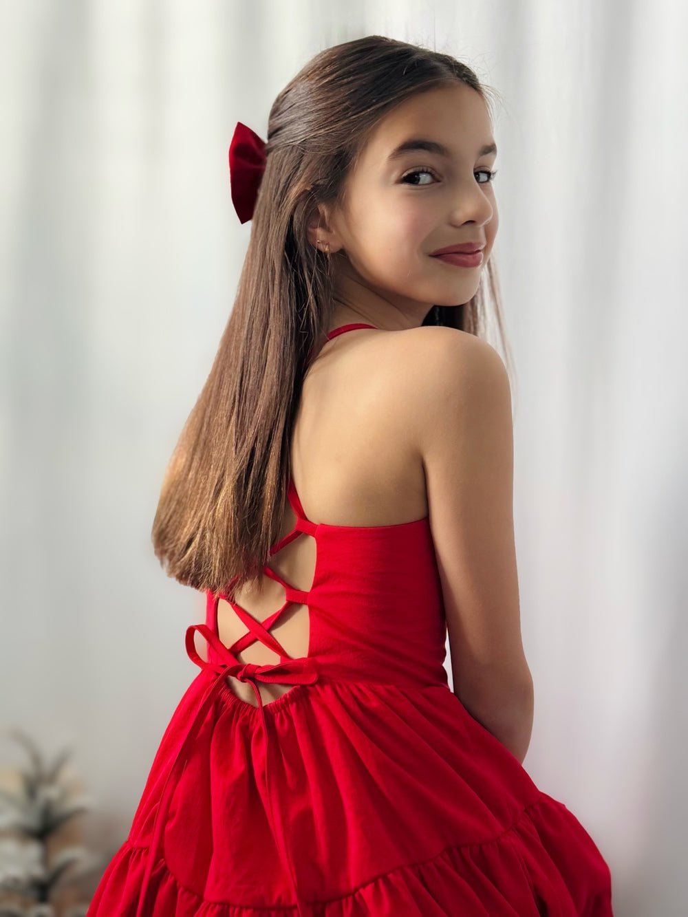 Tween girl in red holiday dress with adjustable bow-tie back