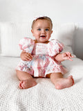 Baby girls rainbow pink baby romper - sitting