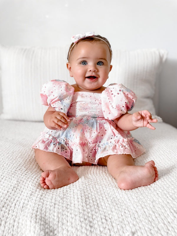 Baby girls rainbow pink baby romper - sitting