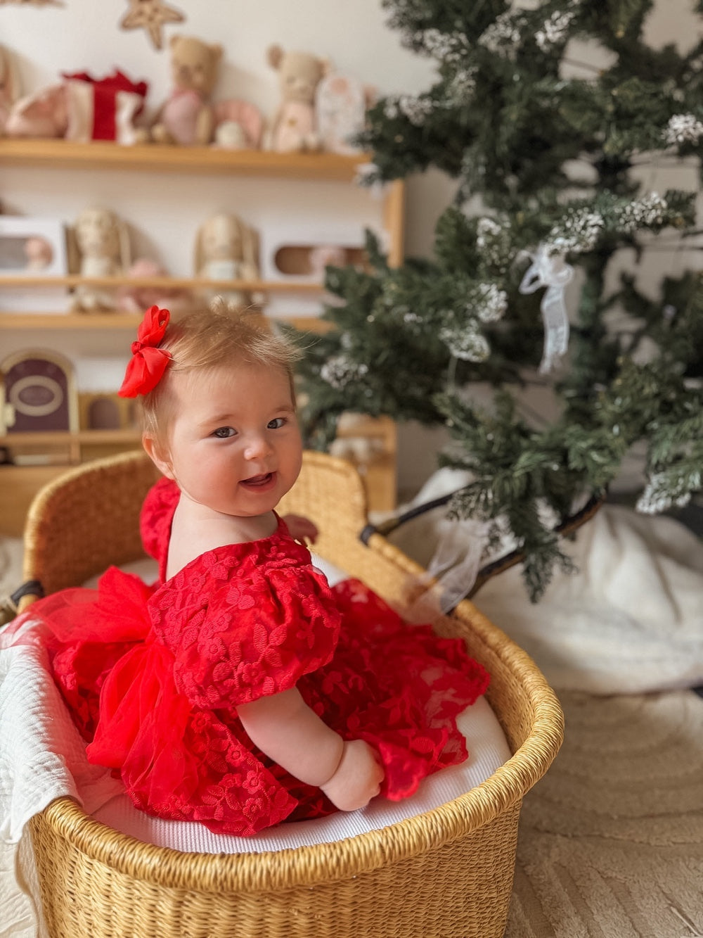Penelope red embroidered baby dress, side view with puff sleeves
