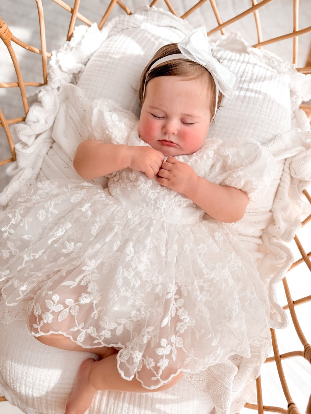 Penelope ivory baby dress back view with statement bow