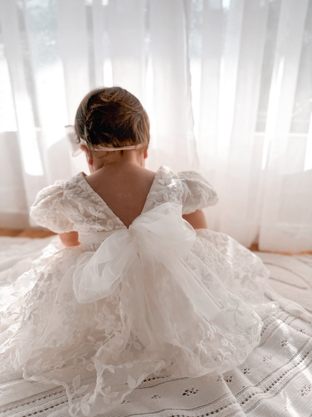 Baby dress back view with statement bow