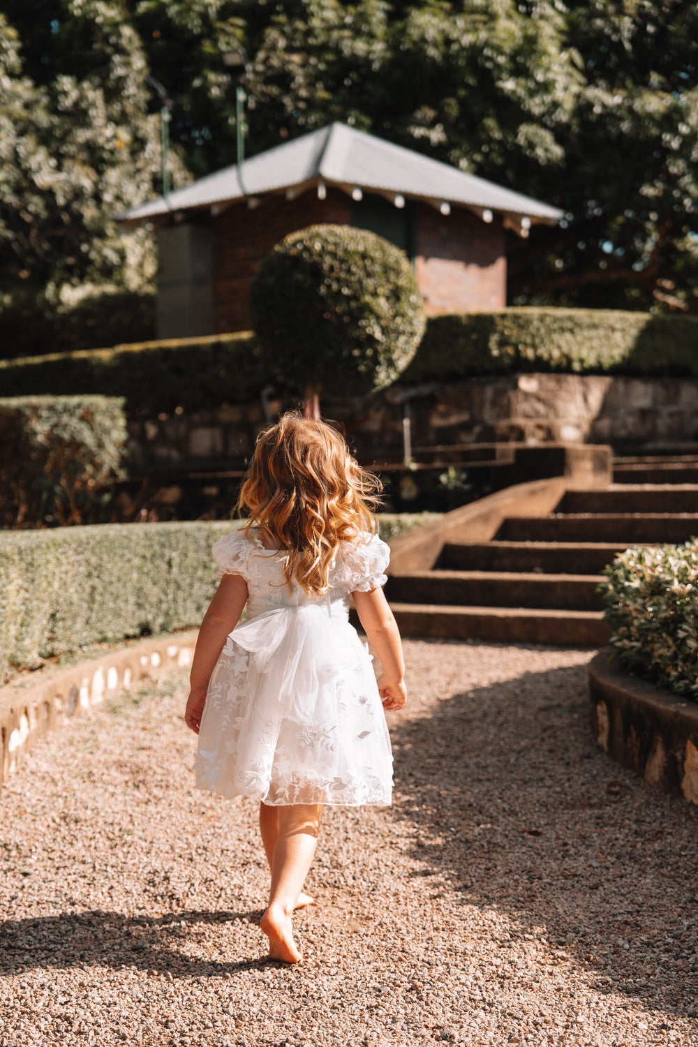 White flower girl dress with delicate petal embroidery