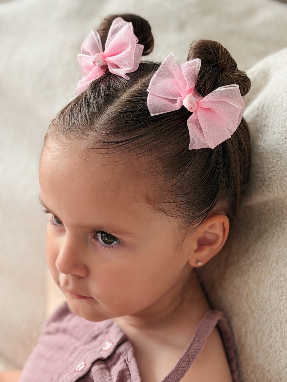 Soft pink bow clips for pigtail hairstyles
