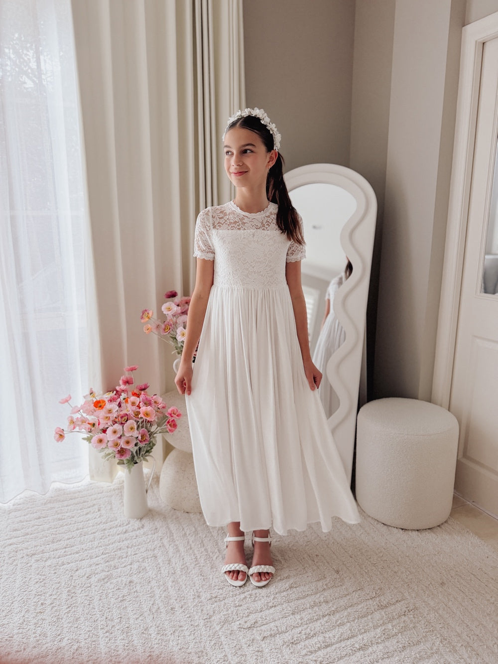 White floral porcelain headband paired with white girls communion dress