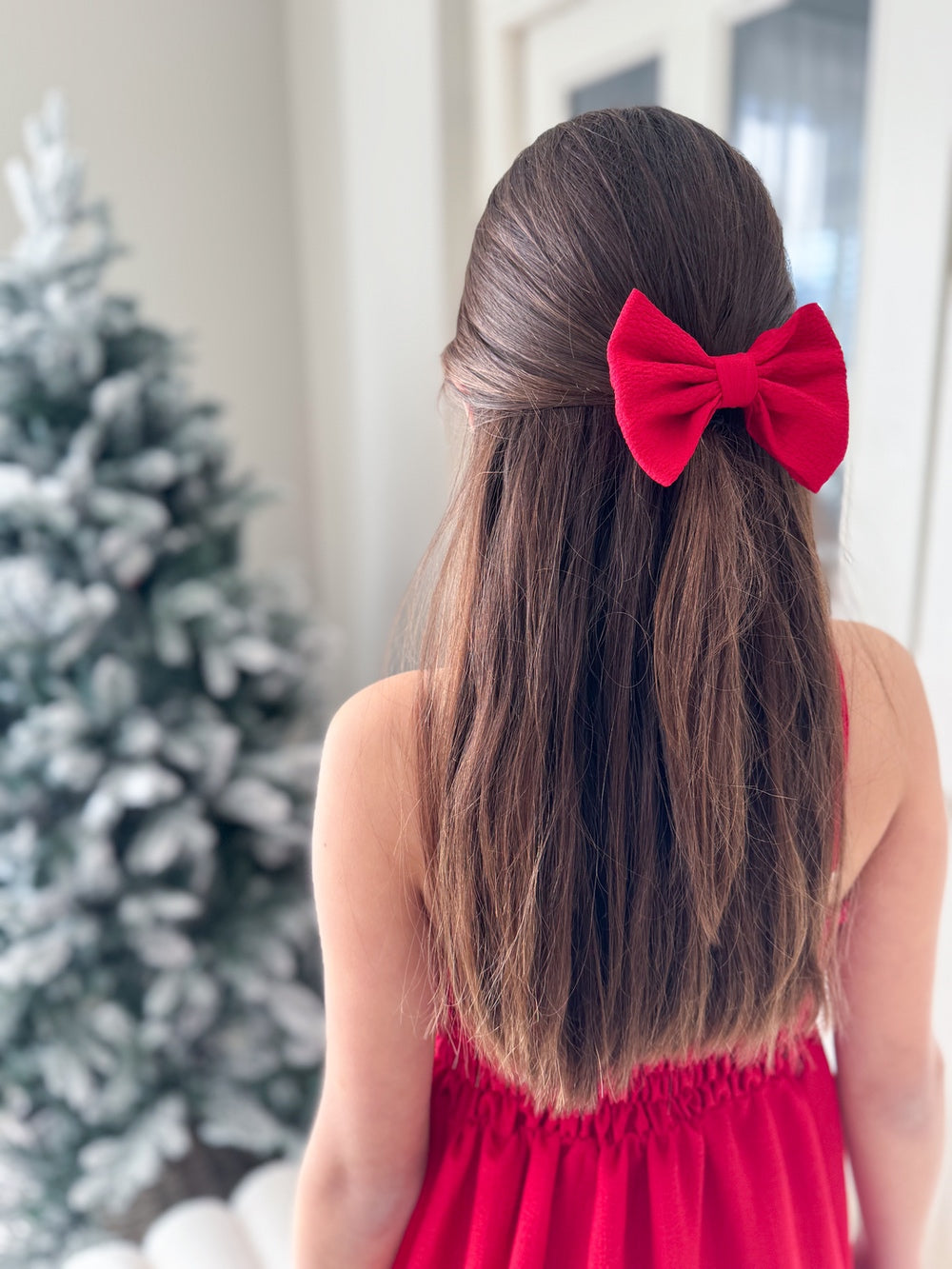 Sabrina Red Girls Hair Bow - Christmas Dresses and RompersGirl wearing The Sabrina red hair bow for a Christmas hairstyle