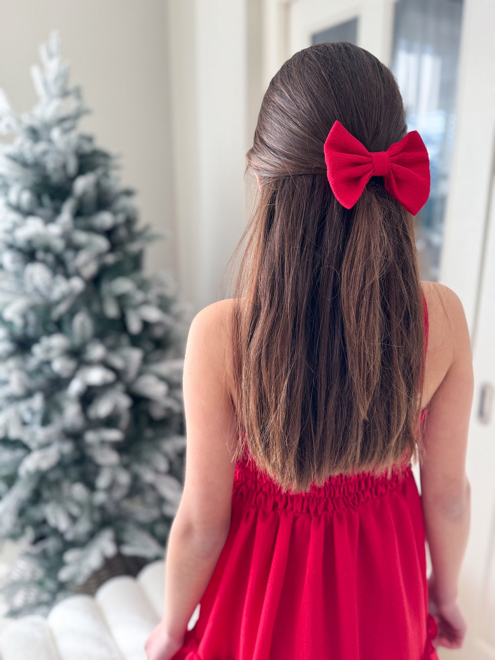 Sabrina Red Girls Hair Bow - Christmas Dresses and RompersClassic red hair bow clipped into half-up style with festive background