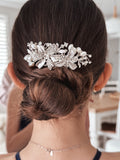 Close-up of silver floral hair comb with white pearls and crystals