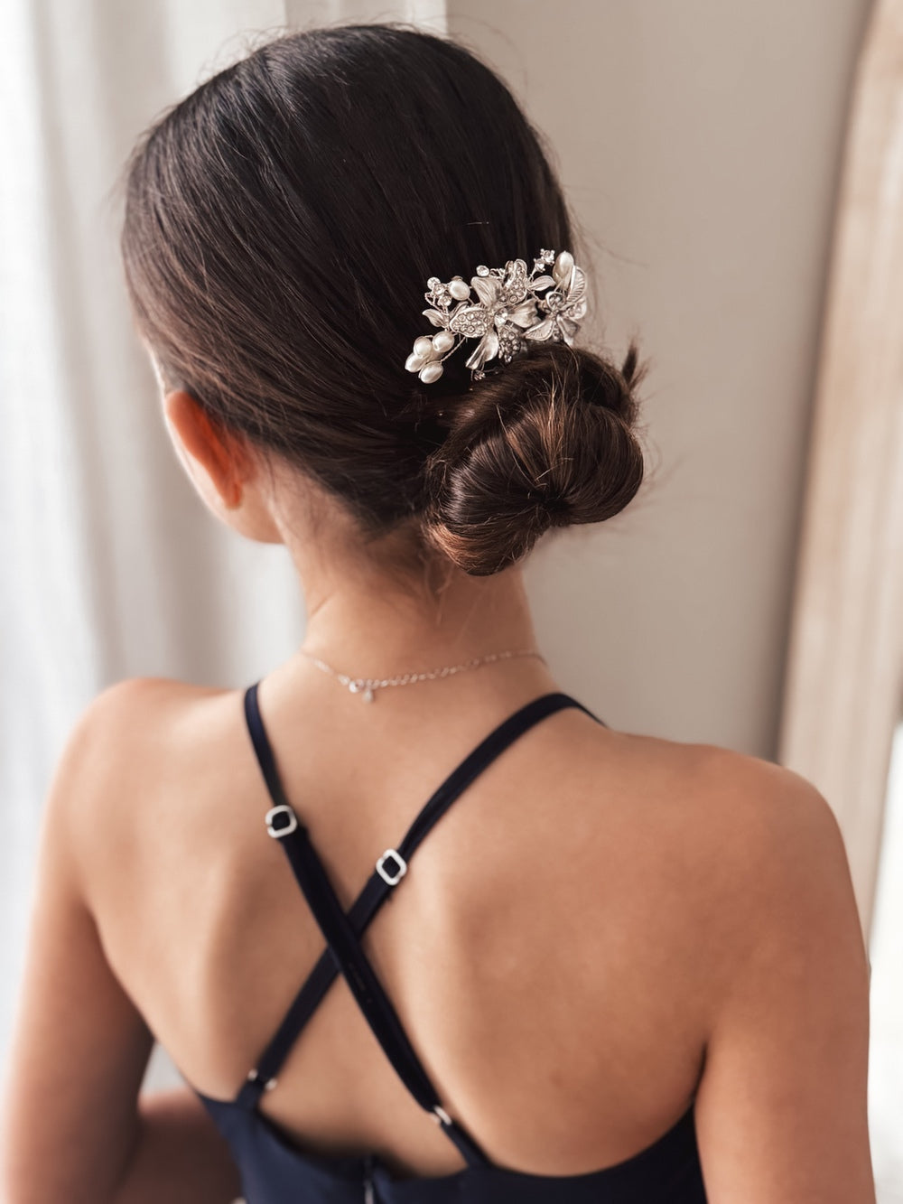 Girl wearing silver flower hair comb with soft curls