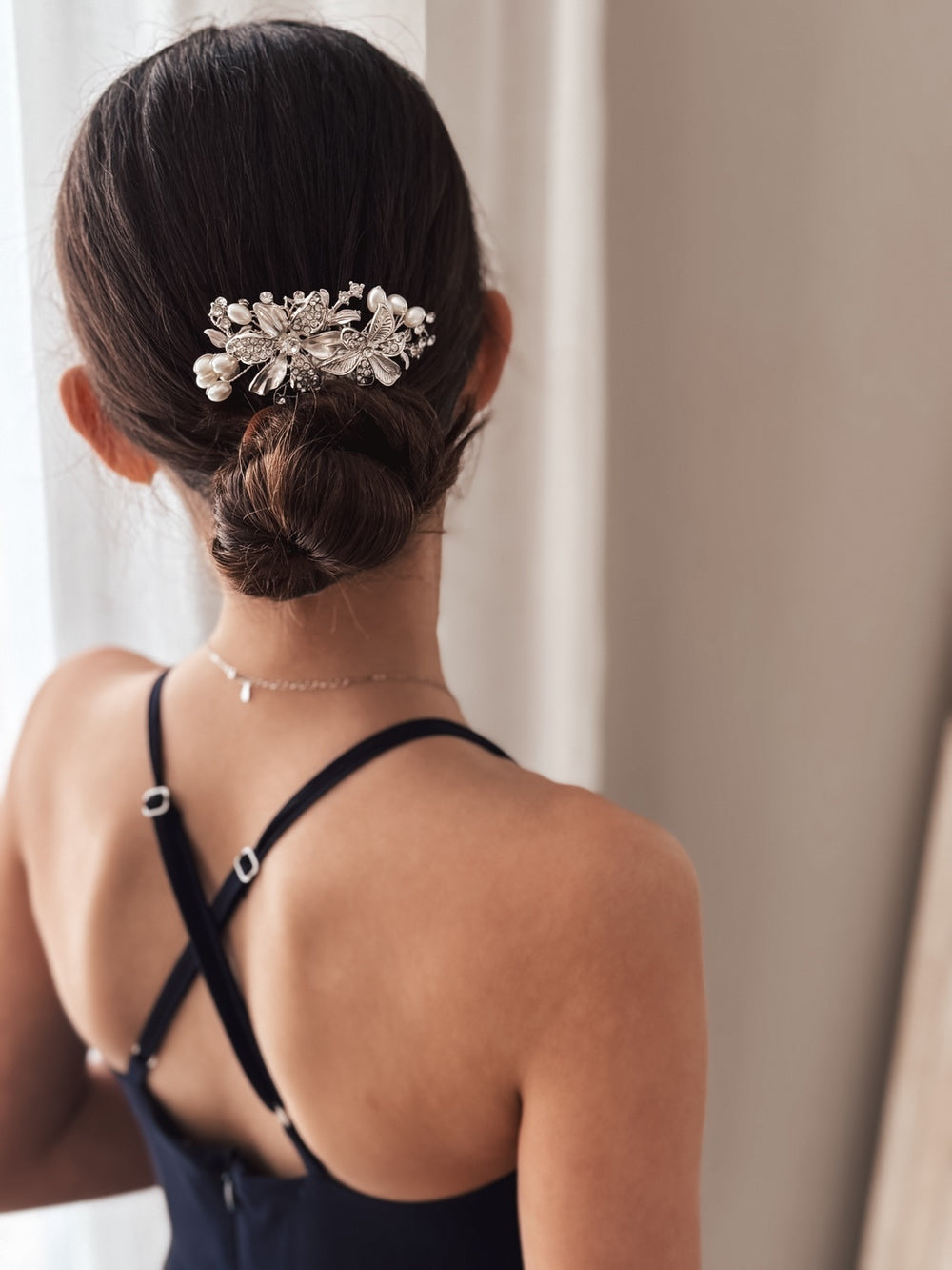 Elegant silver hair accessory with blooming flower and diamante details