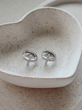Girls Silver Cross Earrings flat lay – sterling silver hoops with delicate crystal-encrusted crosses