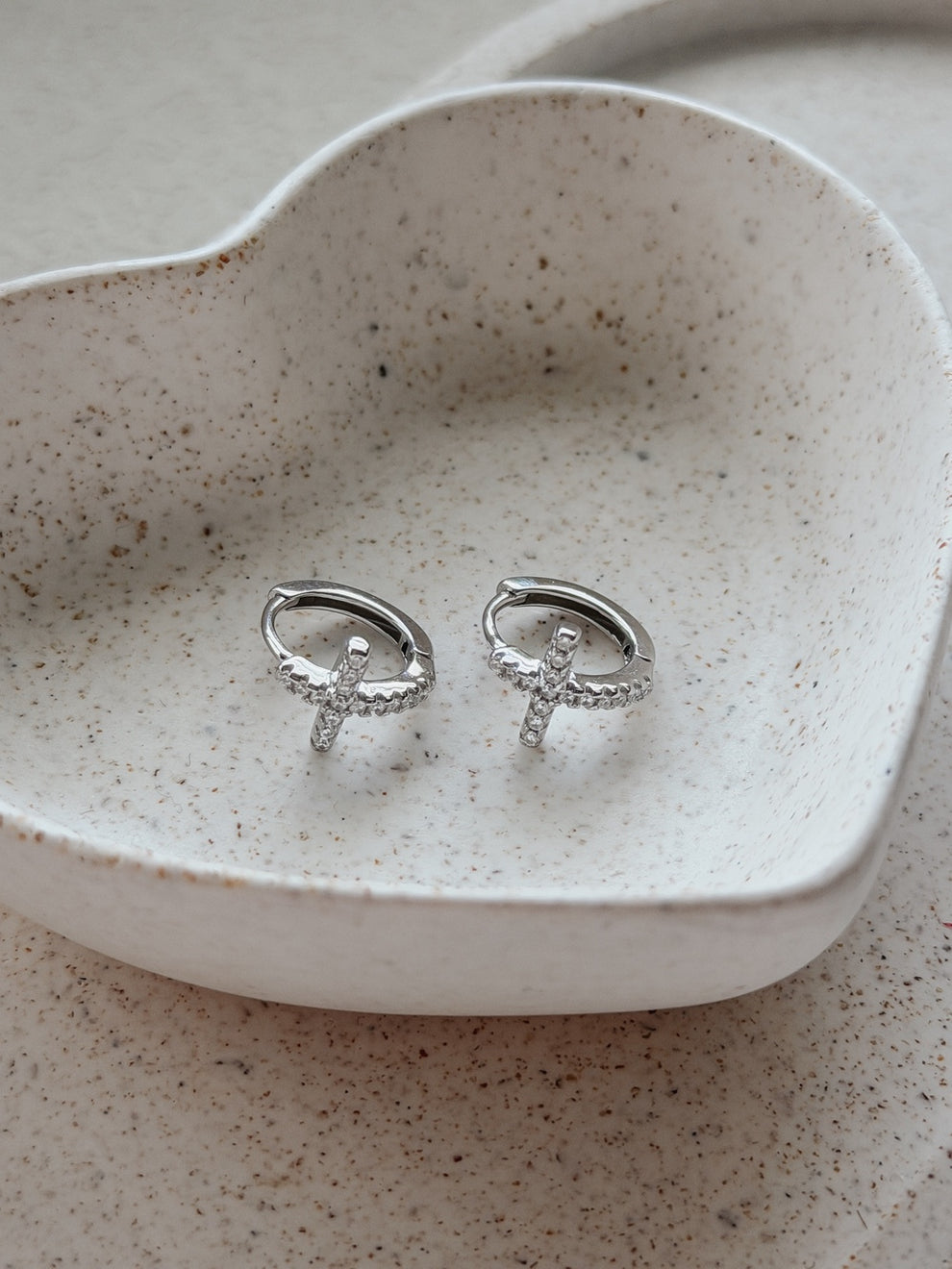 Girls Silver Cross Earrings flat lay – sterling silver hoops with delicate crystal-encrusted crosses