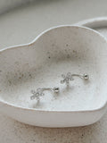 Pair of Girls Silver Flower Earrings displayed in jewellery dish – perfect Communion or gift set