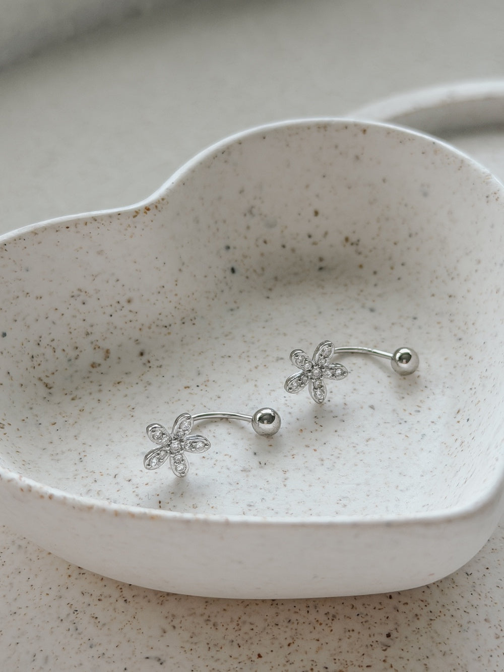 Pair of Girls Silver Flower Earrings displayed in jewellery dish – perfect Communion or gift set