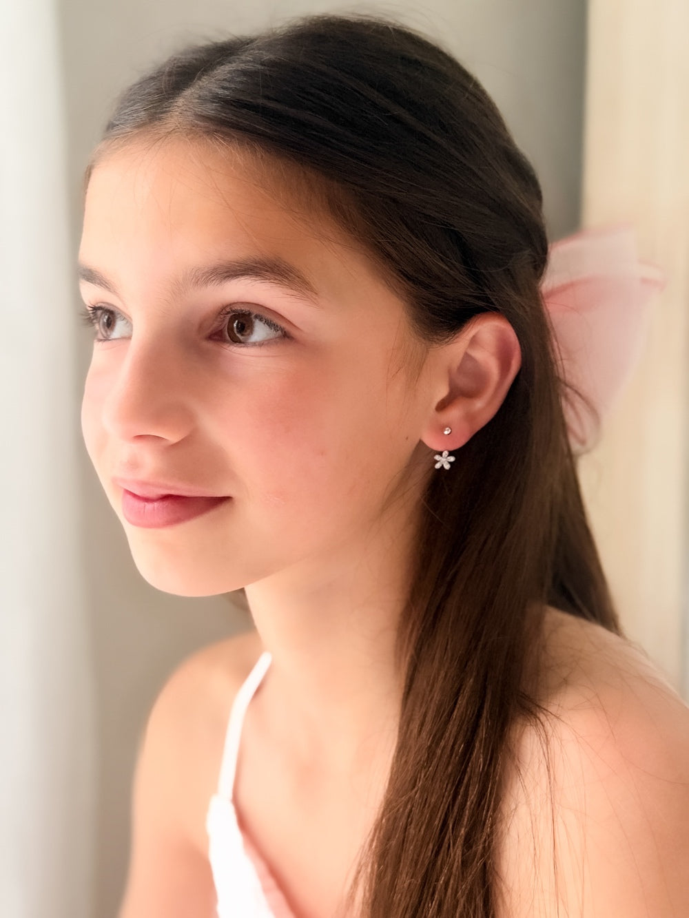 Girls Silver Flower Earrings - Girls and Babies JewelleryClose-up of Girls Silver Flower Earrings showing delicate floral diamante detail on silver hoops