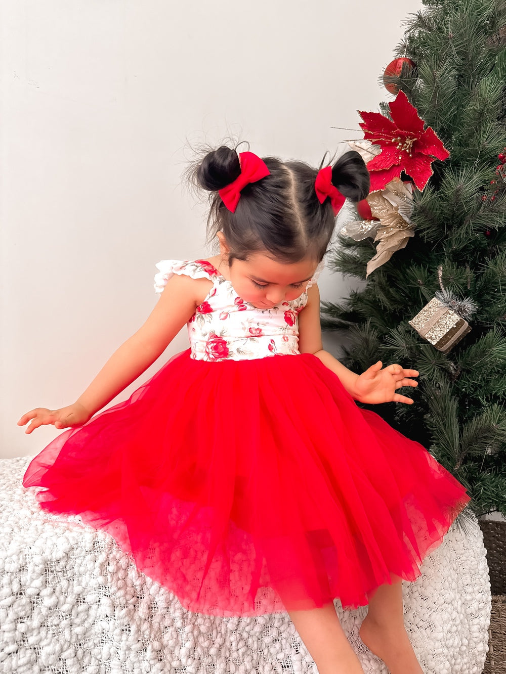Front view of red floral girls Christmas dress with tulle skirt and ruffle shoulders