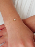 Girls gold cross bracelet with delicate star detail