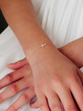 Starlight gold bracelet with cross and sparkle detail