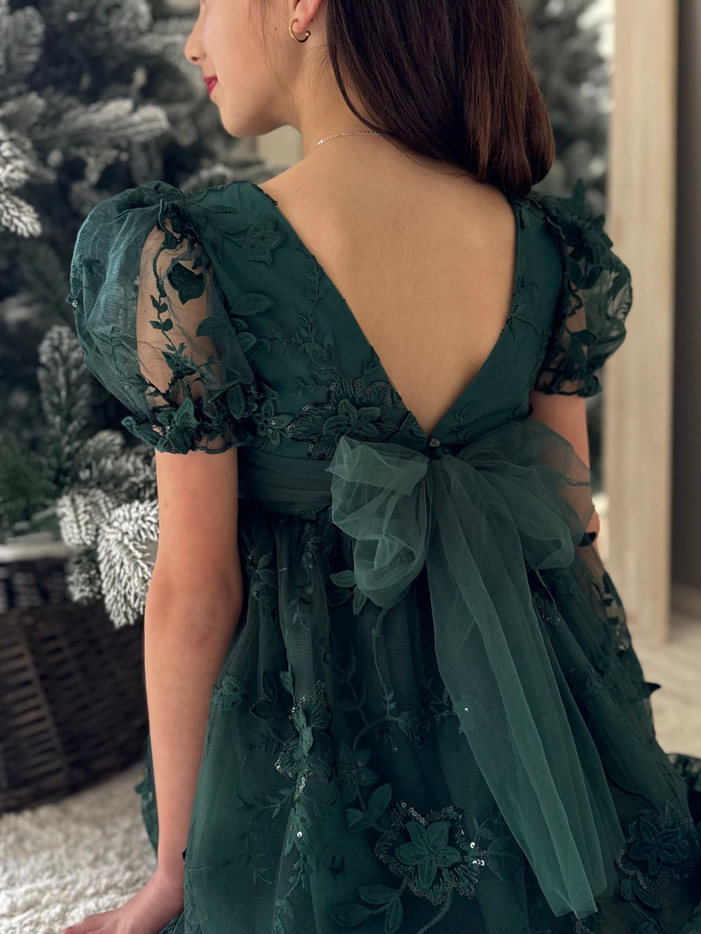 Back of Vienna dress showing large bow and pearl button details