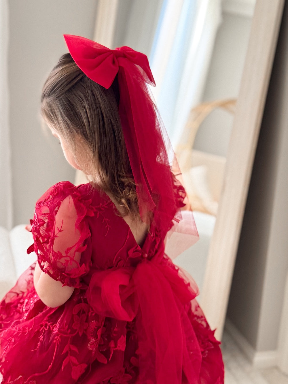 Red Tulle Christmas BowGirls red tulle bow clipped in ponytail for festive look